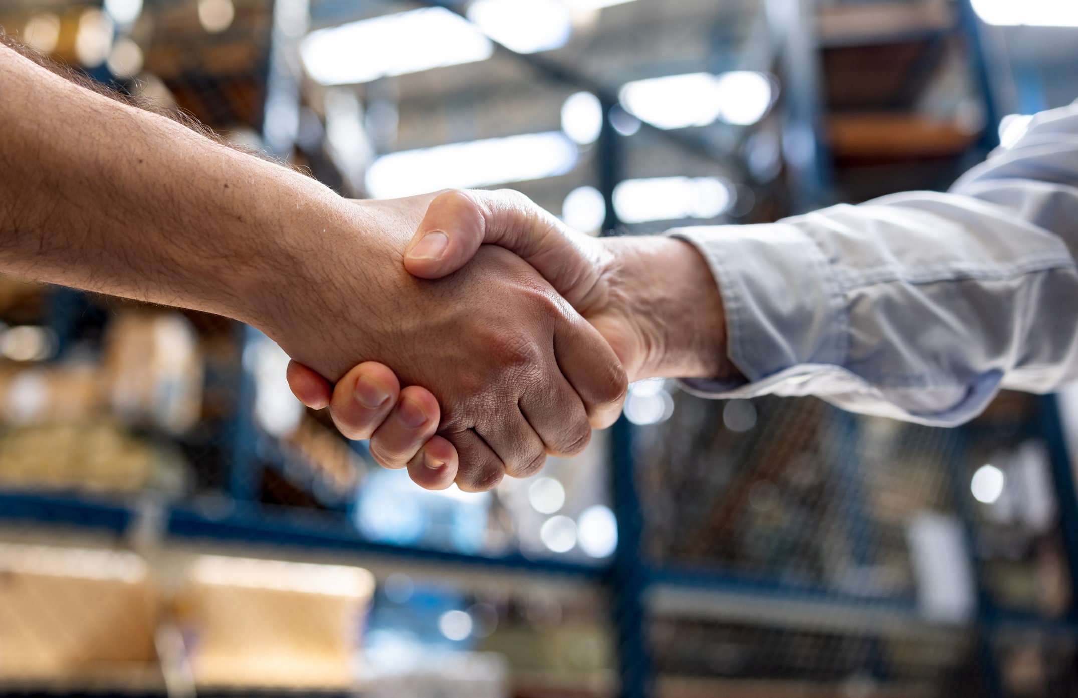Warehouse manager hiring an employee and shaking his hand