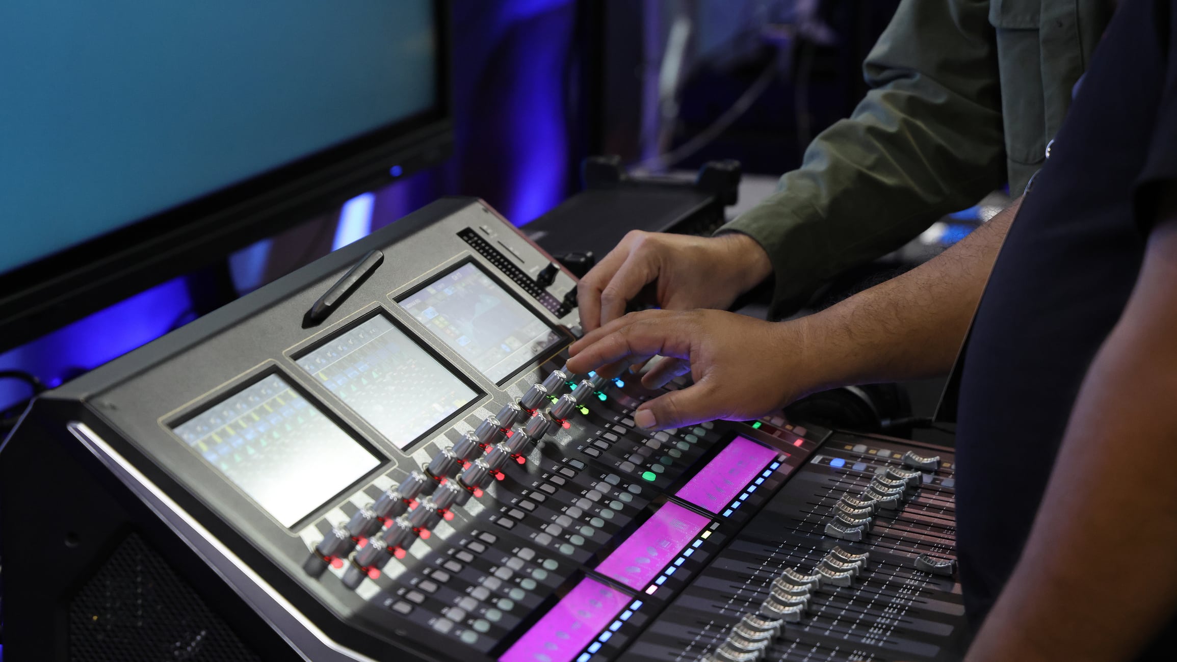 Professional audio or sound engineers operating digital mixing consoles in studio