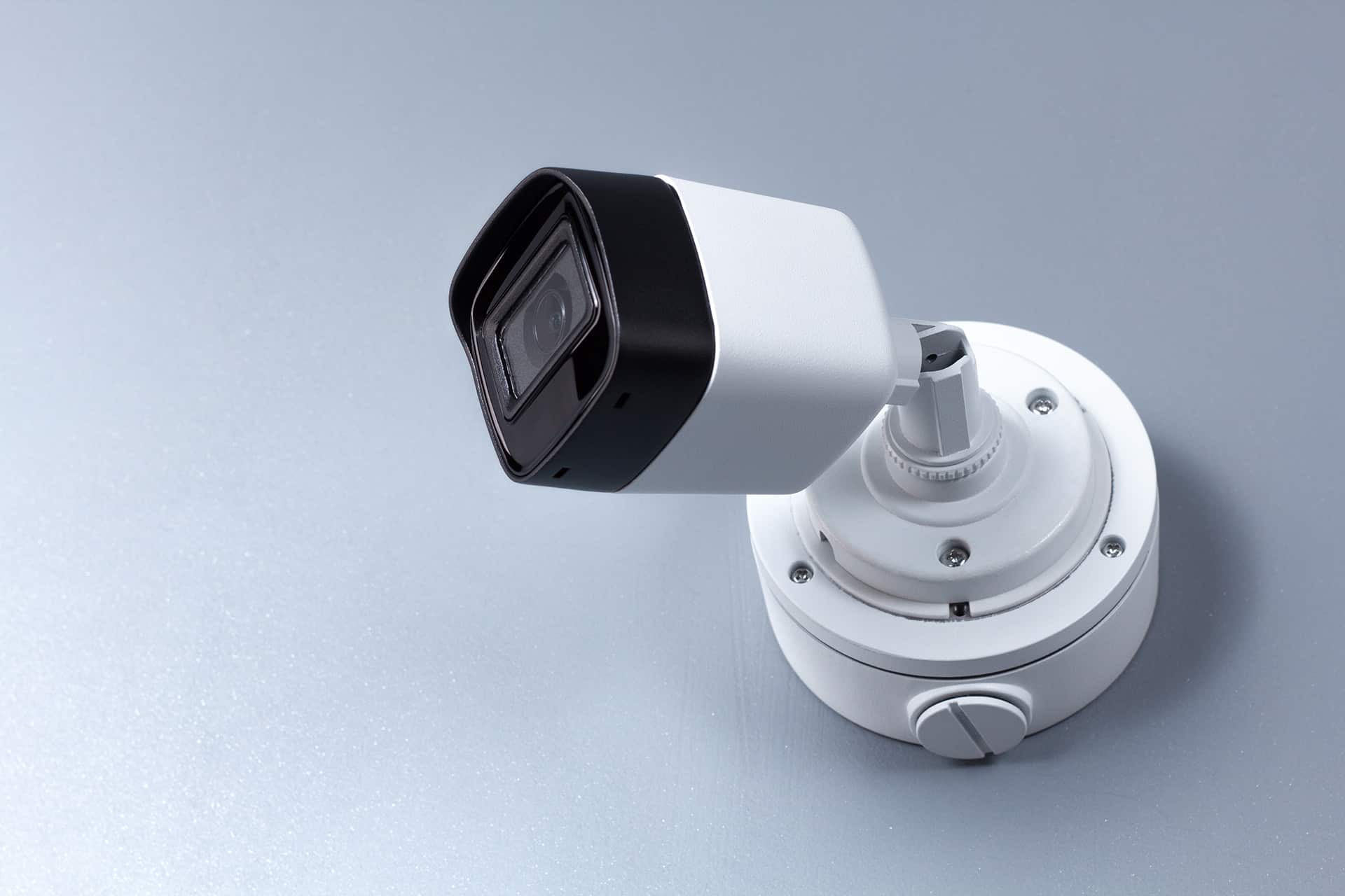 White security camera mounted on a wall, continuously monitoring the room and providing enhanced safety and surveillance through cutting-edge technology and smart design