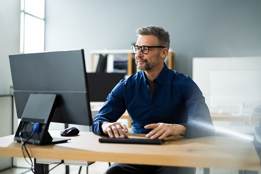 Businessman Using Business Computer In Office Or Workplace