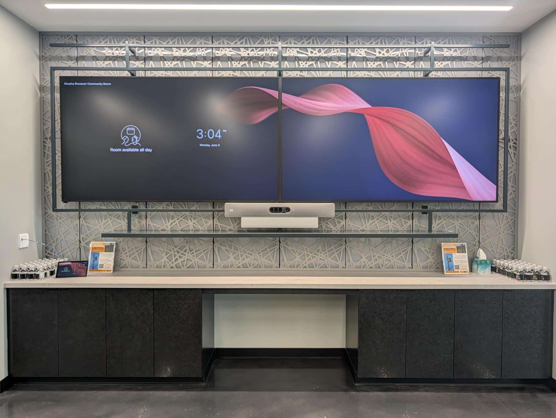 A double monitor/television set up above a concession area.